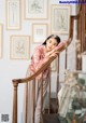 A woman leaning on the railing of a staircase.